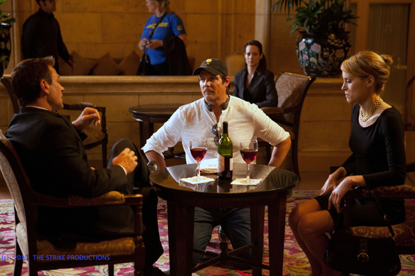 Photo of Taylor Schilling and Grant Bowler with Director Paul Johansson on set