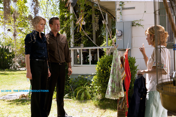 Photo of Dagny Taggart and Hank Rearden talking to Ivy Starnes