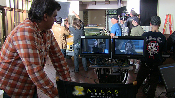 Photo of Jim Manera watching a scene with Dagny Taggart and Cheryl Taggart